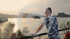Man enjoying magnificent view from cruise ship sailing between islands