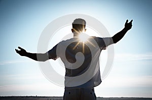 Man enjoying sunny day, back view. Nature healing power