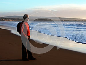 Man enjoying sunset by the ocean