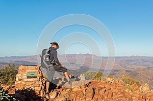 Man enjoying view after a hike to the top of Mount Sonder just outside Alice Springs, West MacDonnel National Park