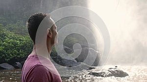 Man enjoying view on huge waterfall