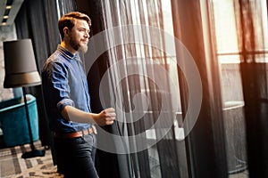 Man enjoying view from luxurious hotel room