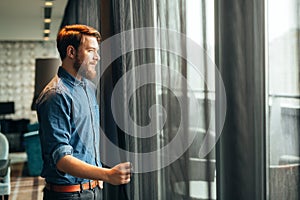 Man enjoying view from luxurious hotel room