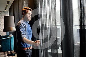 Man enjoying view from luxurious hotel room