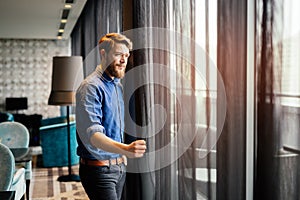 Man enjoying view from luxurious hotel room