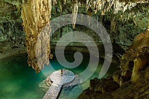 Man enjoying the view of Suytun Cenote from the top Yucatan Mexico North America