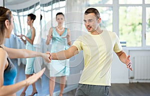 Man enjoying vigorous jive with female partner at dance class