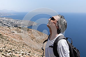 A man enjoys the silence against the backdrop of the seascape, Greece, Crete