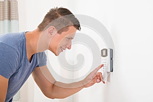 Man entering code in door security system