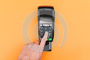 Man entering a password at a POS terminal. Wireless, contactless or cashless payments, RFID NFC. Payment by credit card