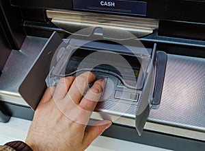 Man Entering Pin into an ATM