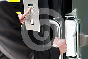 Man entering security code to unlock the door