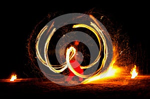 Man entertains with the help of fire, carrying fire performance night.