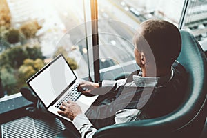 Man entrepreneur on armchair, laptop