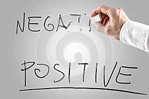 Man erasing Negative over Positive