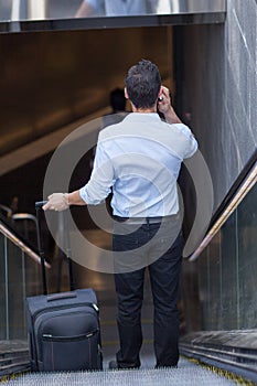 Man on escalator calling