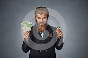 Man with euro cash currency and retro pocket watch