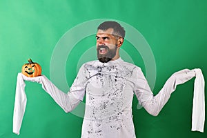 Man with evil face expression on green background