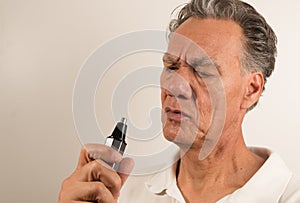 Man Examine his Nose Hair Trimmer