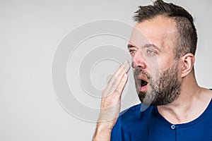 Man examing his breath smell