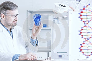 Man examinig the 3D printout photo