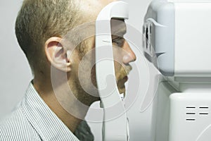 Man examining eyesight in optical clinic.