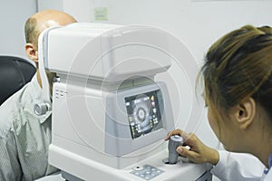 Man examining eyesight in optical clinic.