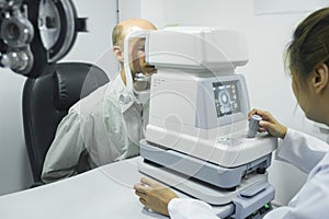 Man examining eyesight in optical clinic.