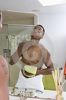 Man Examining Himself In Bathroom Mirror