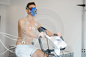 Man examining his cardiovascular system on bike simulator