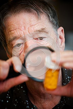 Man examining instructions on medicine bottle