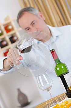 Man examining the wine