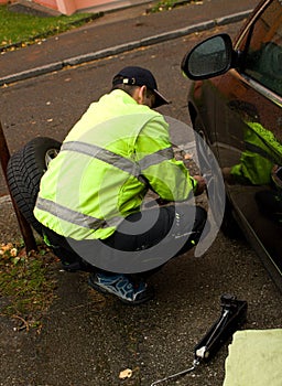 The man exchanges the seasonal wheels