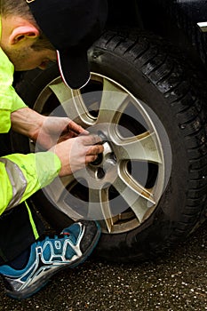 The man exchanges the seasonal wheels