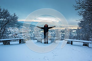 Man Excited by The Beauty of Snowy Bergen City Center in Winter