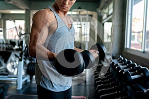 Man Execute Exercise with Dumbbells in Gym