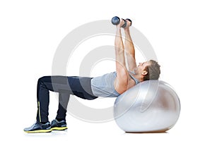 Man, exercise ball or balance in dumbbell workout performance, wellness or studio on white background. Strong male