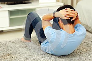 Man exercising abdominals on the floor