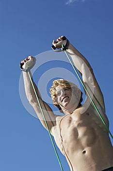 Man Exercising Against Blue Sky