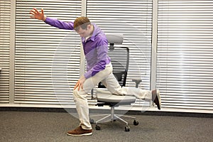 Man exercising on chair in office, healthy lifestyle