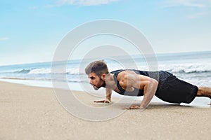 Man Exercising, Doing Push Up Exercises On Beach. Fitness Workout