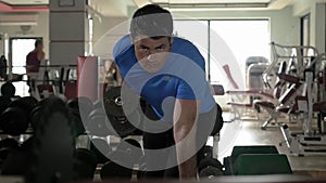 Man exercising with dumbbell in the gym