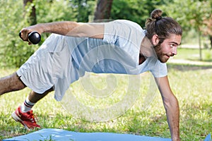 man exercising with dumbbells outdoors
