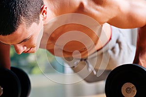 Man exercising in gym - push ups