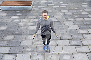 Man exercising with jump-rope outdoors