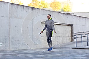 Man exercising with jump-rope outdoors