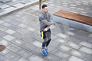 Man exercising with jump-rope outdoors