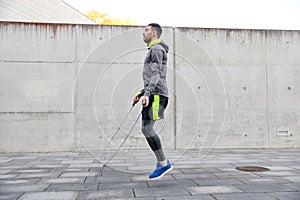 Man exercising with jump-rope outdoors