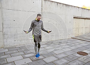 Man exercising with jump-rope outdoors