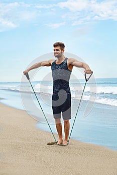 Man Exercising Outdoor, Doing Workout Exercise At Beach. Fitness